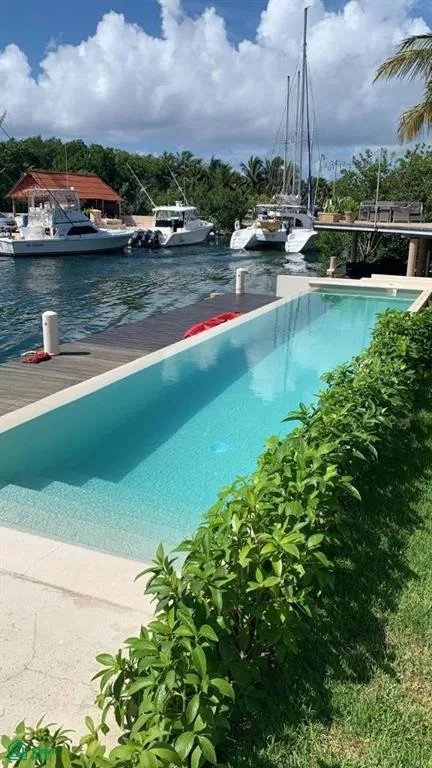 Modern 2-Bedroom Canal-Front Condo with Private Dock in Puerto Aventuras